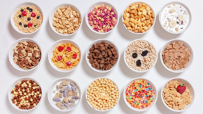 12 white bowls of different extruded cereals
